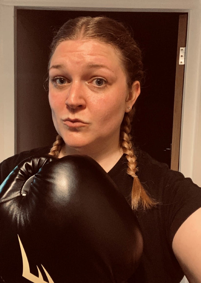 Nicola Barnard, a woman wearing a black boxing glove